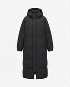 Women’s longer cold blocker puffer coat with walking slit, high closing collar and noise-reducing outer material