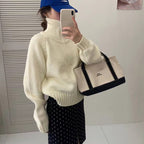 Modern knit pullover with stand-up collar and zipper