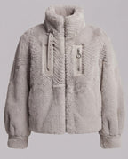 Women's cozy faux fur jacket with stand-up collar, zippered pocket and feminine balloon sleeve silhouette