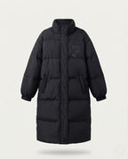 Women's longer boxy thermo puffer with high stand-up collar, college patch, and noise-reducing outer shell