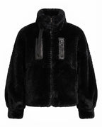 Women's cozy faux fur jacket with stand-up collar, zippered pocket and feminine balloon sleeve silhouette
