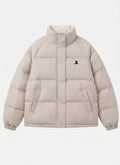 Women's short oversized quilted jacket with high-closing collar and concealed press stud placket