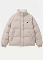Women's short oversized quilted jacket with high-closing collar and concealed press stud placket