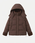Women's short quilted travel-friendly winter parka with teddy cuffs, stowable hood, and spacious side pockets