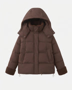 Women's short quilted travel-friendly winter parka with teddy cuffs, stowable hood, and spacious side pockets