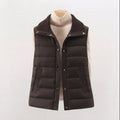 Women's non-padded quilted gilet with high ribbed shawl collar and concealed snap button placket