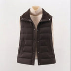 Women's non-padded quilted gilet with high ribbed shawl collar and concealed snap button placket