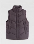 Women's non-padded quilted vest with high stand-up collar, adjustable drawstring hem, and generous flap pockets