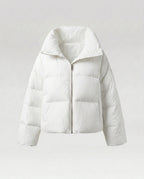 Women's cropped quilted jacket with oversized hood, lightweight thermal filling, and rounded hem
