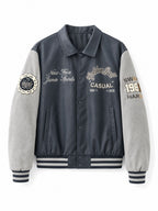 Men's varsity bomber jacket in collegiate style with faux leather body, suede look sleeves and embroidered patches Fashion Glam