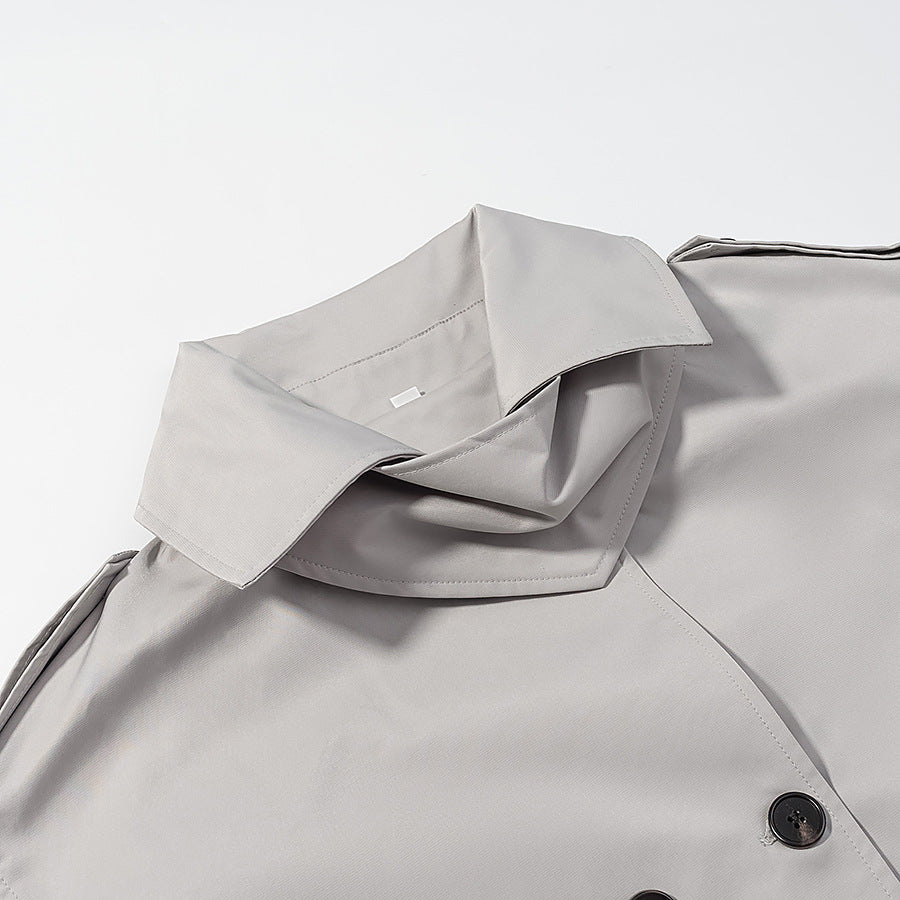 Women's short trench-style jacket with high standing collar, double-breasted front and waist belt Fashion Glam