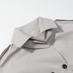 Women's short trench-style jacket with high standing collar, double-breasted front and waist belt Fashion Glam
