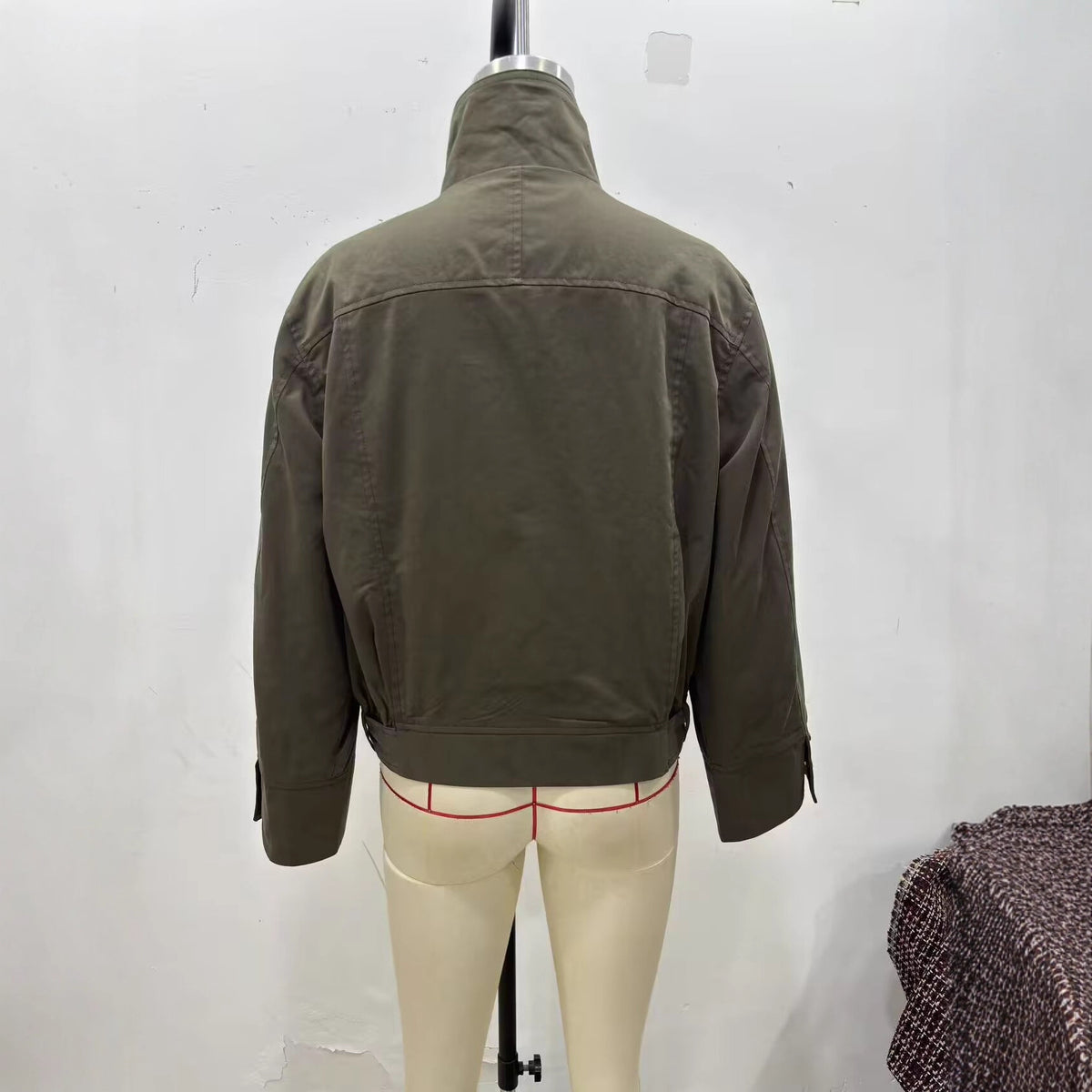 Women's short jacket with high stand-up collar, concealed zipper, and waist belt Fashion Glam