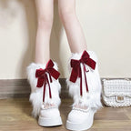 Ladies cozy boot cuffs made of faux fur with bow appliqué and pompons Fashion Glam