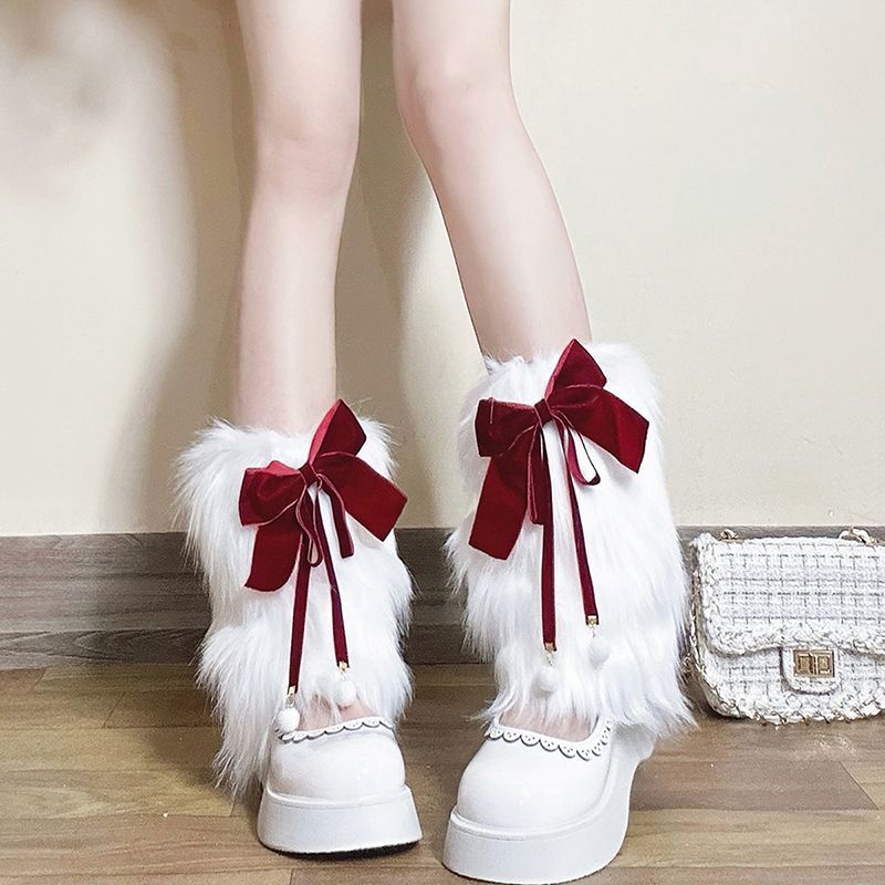 Ladies cozy boot cuffs made of faux fur with bow appliqué and pompons Fashion Glam