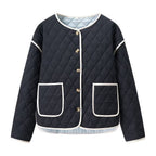 Women's short-cut quilted transitional jacket with round neck, decorative piping, and turn-up cuffs Fashion Glam