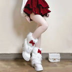 Ladies cozy boot cuffs made of faux fur with bow appliqué and pompons Fashion Glam