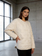 Women's short cut quilted jacket with round neckline and tonal bow quilting Fashion Glam