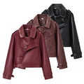 Ladies short cut biker jacket made of faux leather with asymmetrical front and waist belt Fashion Glam