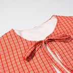 Ladies short cape jacket with check print and decorative tie bow Fashion Glam