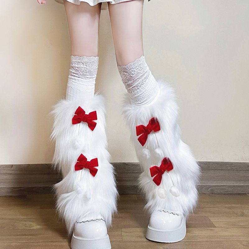 Ladies cozy boot cuffs made of faux fur with bow appliqué and pompons Fashion Glam