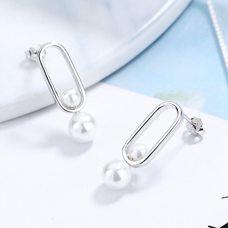 Women's stud earrings with modern oval design and elegant pearls Fashion Glam