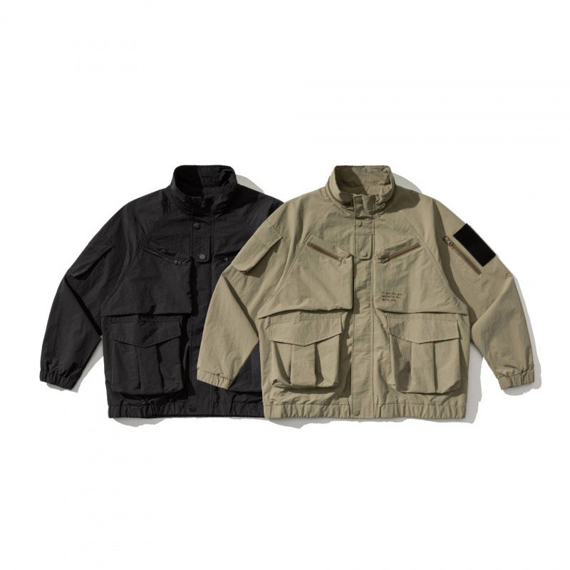 Unisex Oversize Utility Jacket with multifunctional pockets, high stand-up collar, and elastic hem Fashion Glam