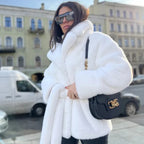 Women’s short coat made of dense faux fur with a tie belt and high stand-up collar Fashion Glam