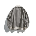 Unisex boxy bomber jacket in herringbone look with ribbed cuffs, flap pockets, and concealed snap button placket Fashion Glam
