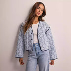 Women's lightweight quilted blouse jacket with V-neck, contrast piping and floral line print Fashion Glam