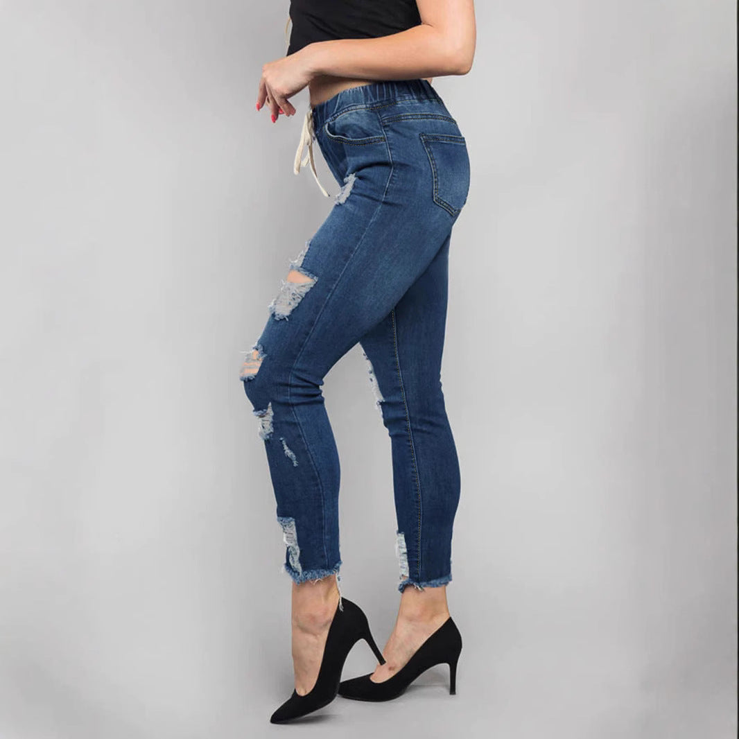 Women High-Waisted Destroyed Jogger Jeans with Elastic Drawstring Waistband and Cropped Frayed Hem Fashion Glam