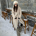 Women's hooded coat made of faux fur with a waist belt and extra soft teddy finish Fashion Glam