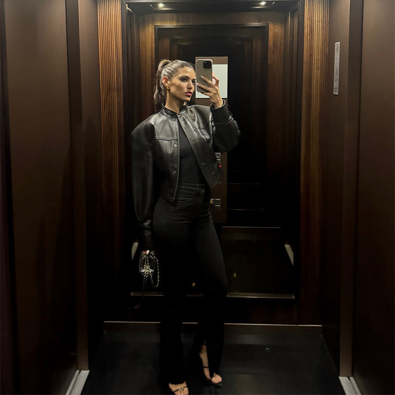 Women's short jacket in biker-bomber style made of vegan leather with a stand-up collar and oversized sleeves Fashion Glam