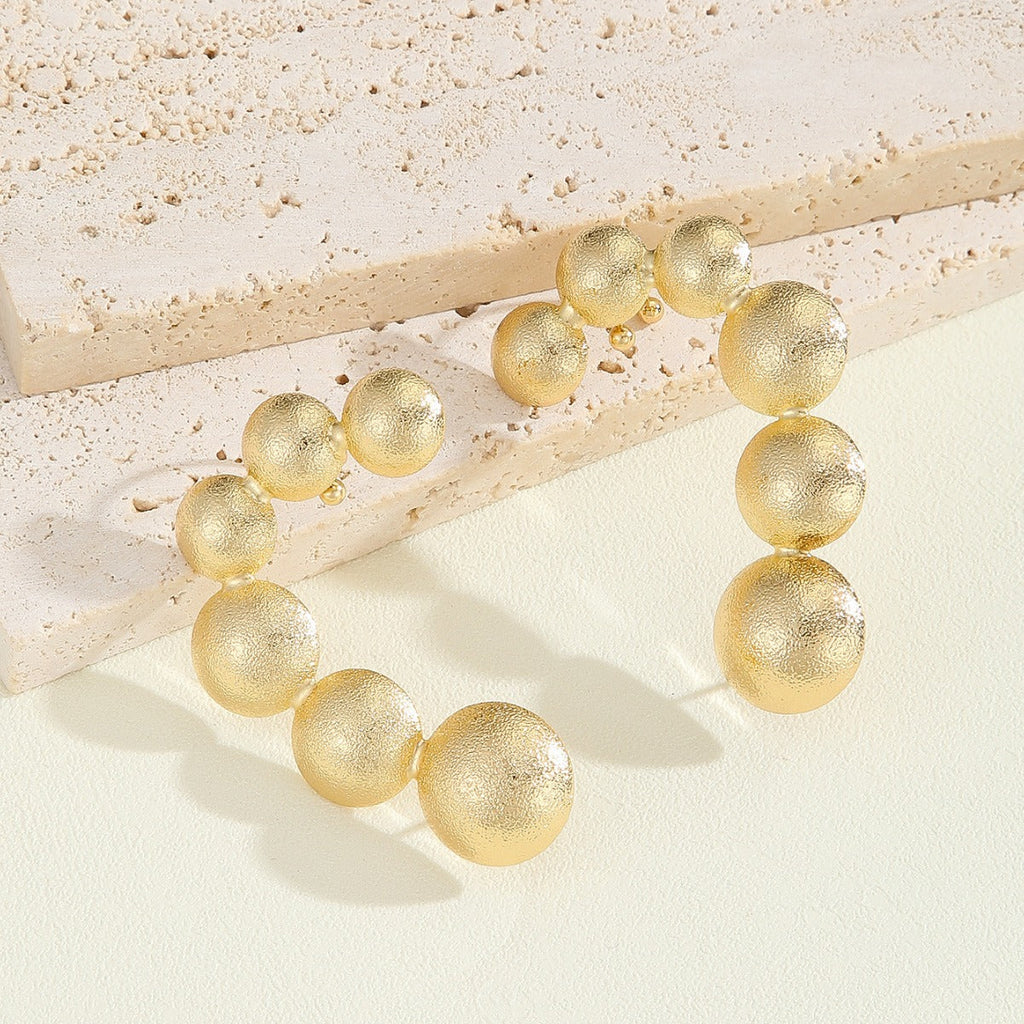 Women's bracelet with structured, golden beads Fashion Glam