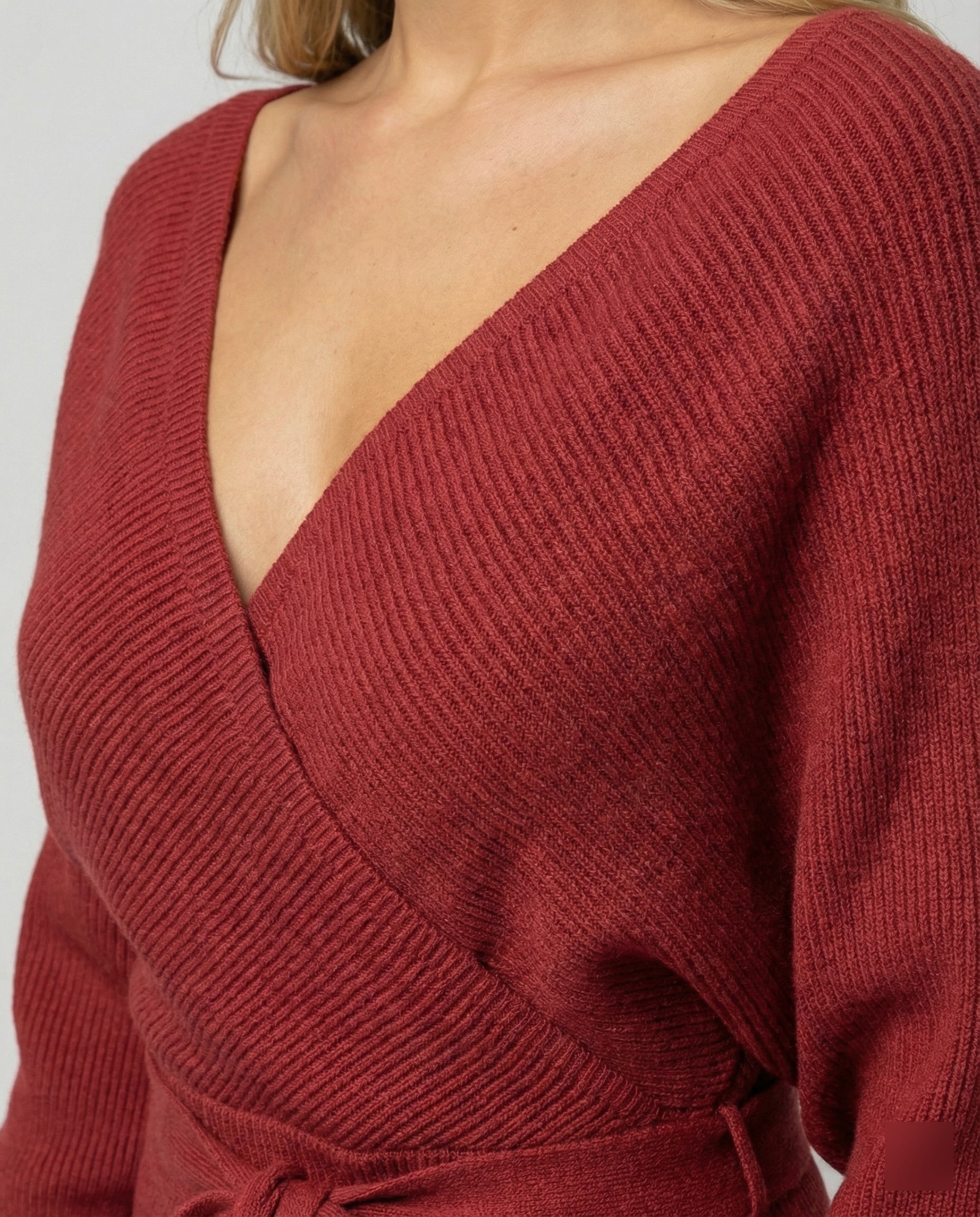 Women's knitted dress with elegant wrap design and decorative belt