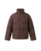 Women's short boxy travel puffer jacket with high collar, reinforced thermal lining, and elastic cuffs