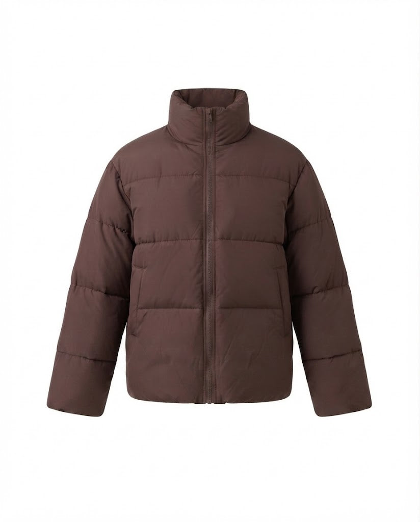 Women's short boxy travel puffer jacket with high collar, reinforced thermal lining, and elastic cuffs